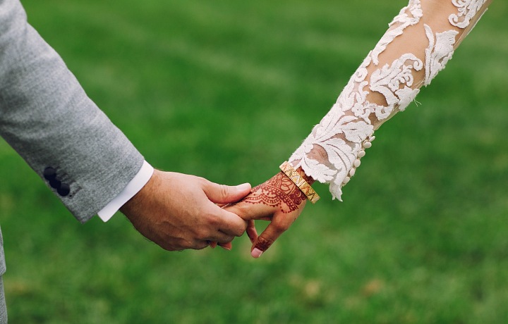 The newlywed is passing the golden bracelet from hand to hand