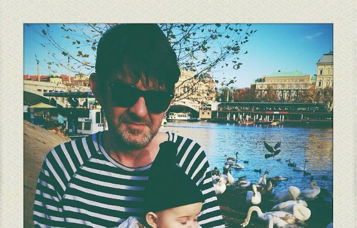 John with his family lives in Prague