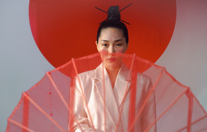 A Japanese woman is holding a parasol.